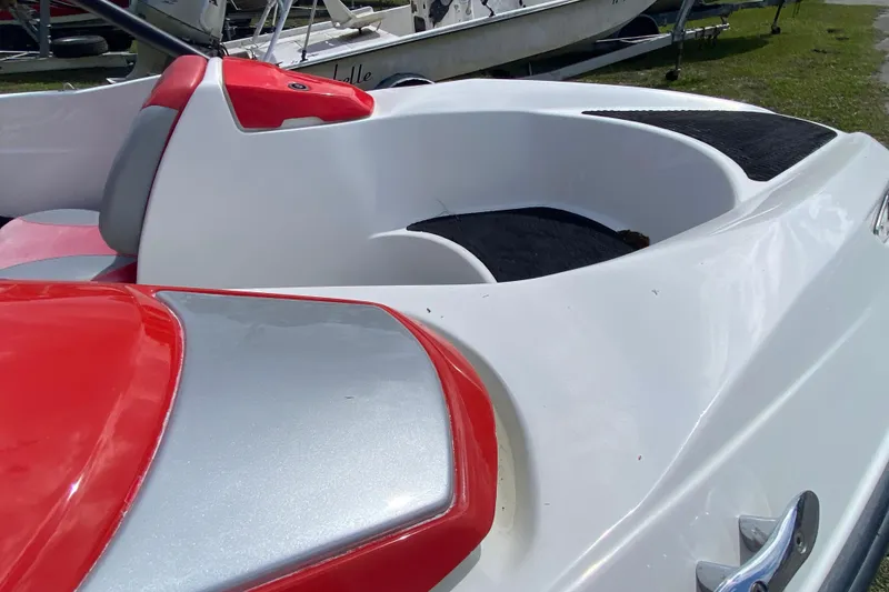 Slide: The Image of 2007 Seadoo 150 Speedster boat interior with red and gray seating, sleek design. - 7
