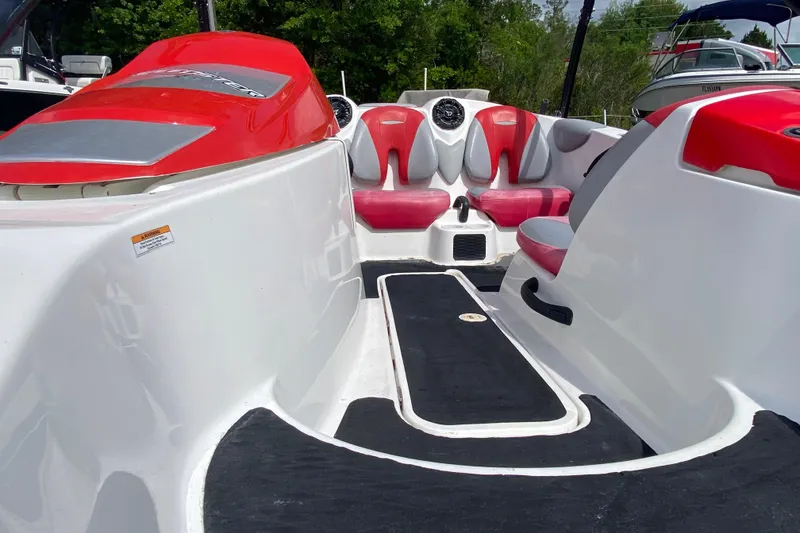Slide: The Image of 2007 Seadoo 150 Speedster interior with red and white seating, black flooring, and dashboard. - 8