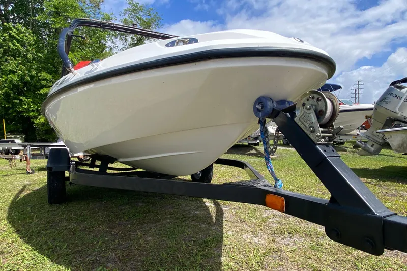 Slide: The Image of 2007 Seadoo 150 Speedster boat on trailer, parked on grass under blue sky. - 9
