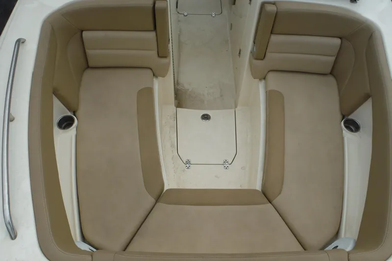 Slide: The Image of 2017 Scout 255 Dorado boat interior with tan cushioned seating and cup holders. - 12