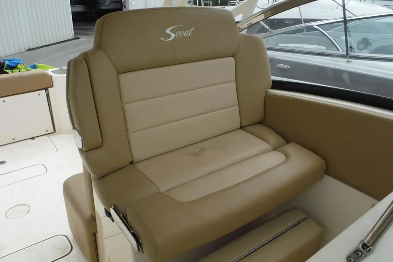 Slide: The Image of 2017 Scout 255 Dorado boat seat with beige upholstery and logo. - 14