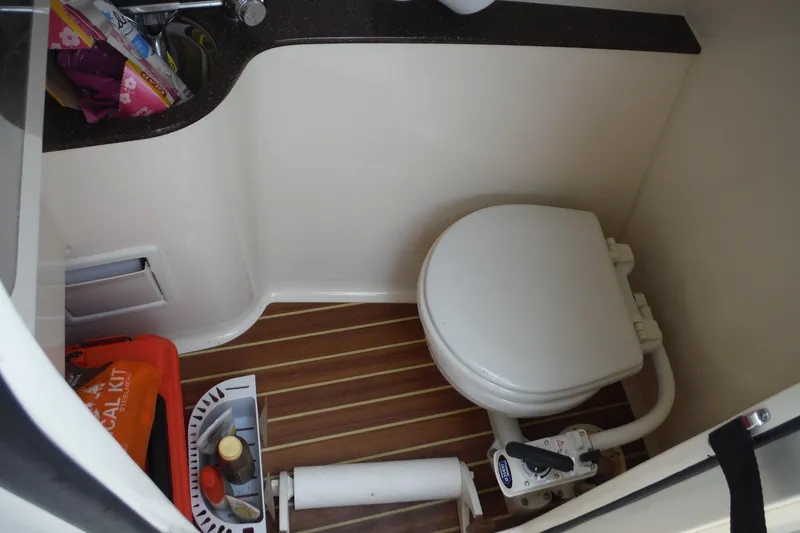 Slide: The Image of 2017 Scout 255 Dorado boat bathroom with toilet, sink, and storage. - 17