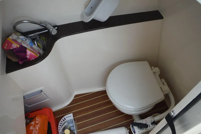 Slide: The Image of Compact bathroom in 2017 Scout 255 Dorado boat with toilet and sink. - 18