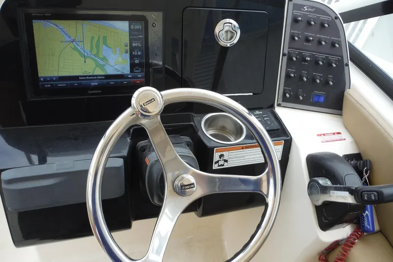 Slide: The Image of 2017 Scout 255 Dorado boat dashboard with steering wheel and navigation system. - 24