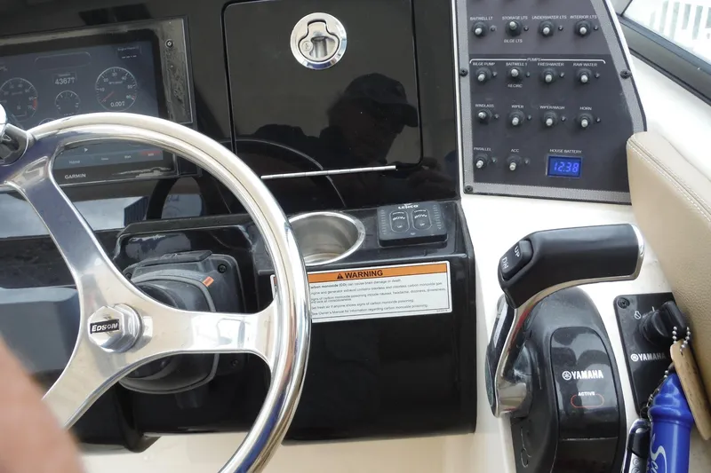 Slide: The Image of 2017 Scout 255 Dorado boat dashboard with steering wheel and control panel. - 25