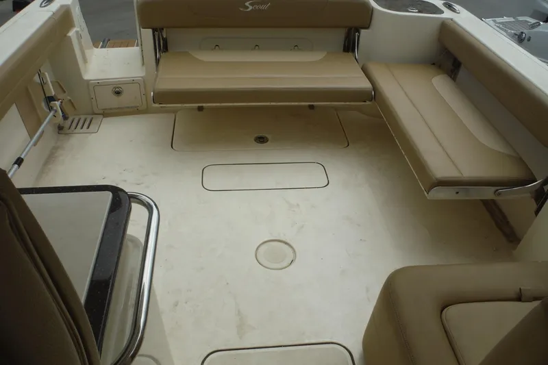 Slide: The Image of 2017 Scout 255 Dorado boat interior with beige seating and spacious deck layout. - 26