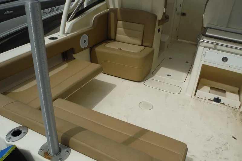 Slide: The Image of 2017 Scout 255 Dorado boat interior with tan seating and storage compartments. - 28