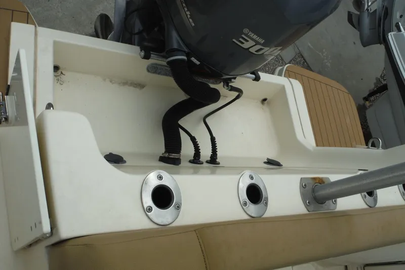 Slide: The Image of 2017 Scout 255 Dorado boat with Yamaha 300 engine, featuring rod holders and seating area. - 34