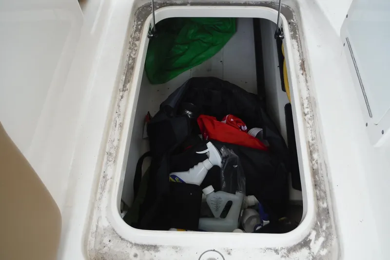 Slide: The Image of Storage compartment of 2017 Scout 255 Dorado boat with various items inside. - 38