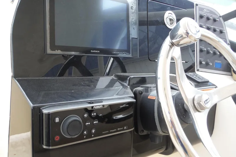 Slide: The Image of Steering console of 2017 Scout 255 Dorado with Garmin display and Fusion audio system. - 39