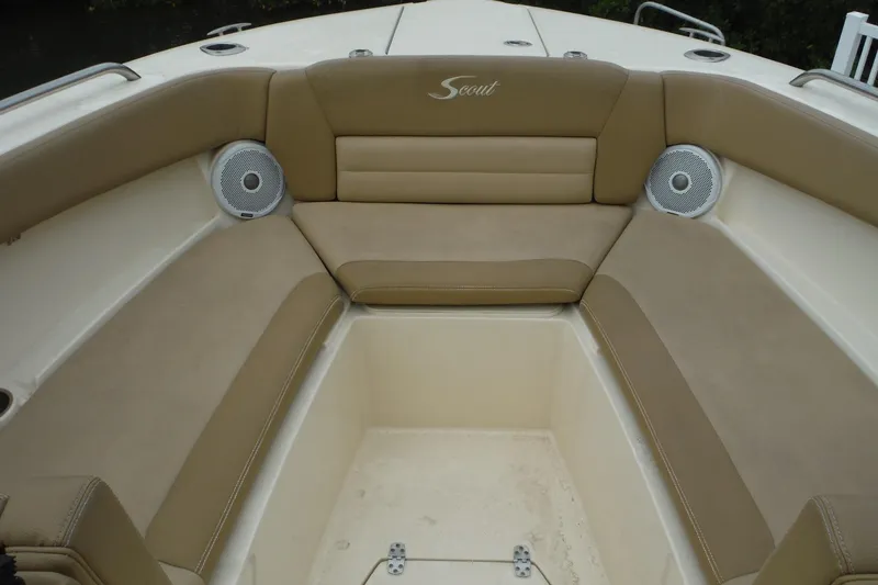 Slide: The Image of 2017 Scout 255 Dorado boat interior with tan seating and built-in speakers. - 9