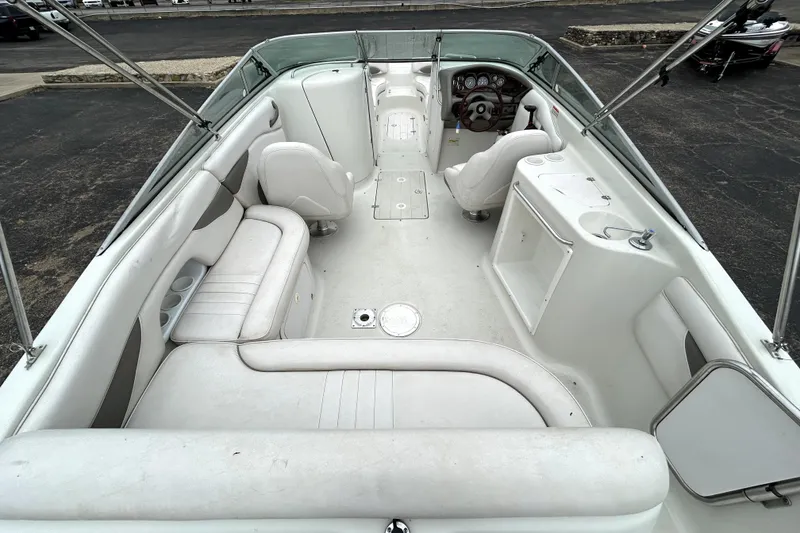 Slide: The Image of 2001 Crownline 239 DB boat interior with white seating and dashboard view. - 10