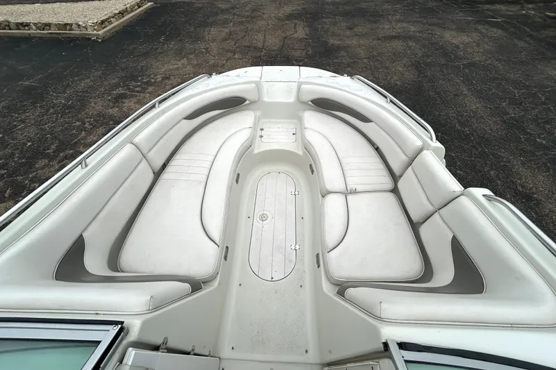 Slide: The Image of 2001 Crownline 239 DB boat interior with spacious white seating arrangement. - 12