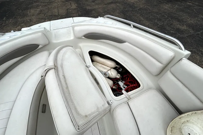 Slide: The Image of 2001 Crownline 239 DB boat interior with open storage compartment, revealing ropes and fenders. - 16