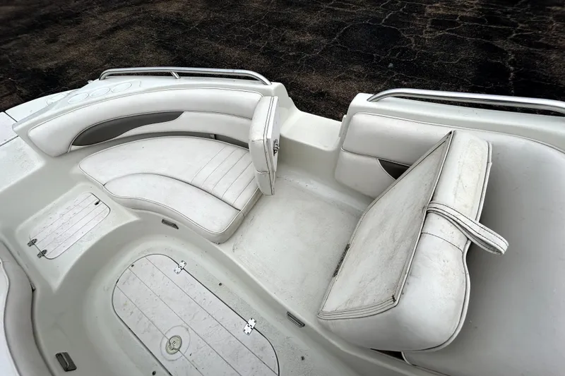 Slide: The Image of 2001 Crownline 239 DB boat interior with white seating and storage compartments. - 18