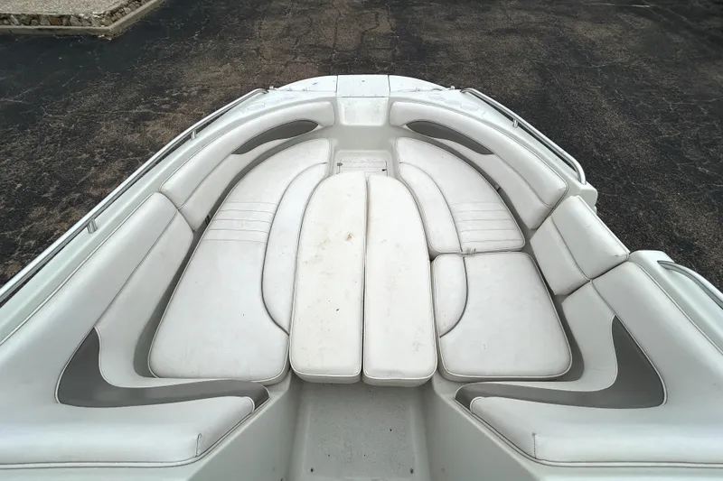 Slide: The Image of 2001 Crownline 239 DB boat interior with white cushioned seating arrangement. - 21