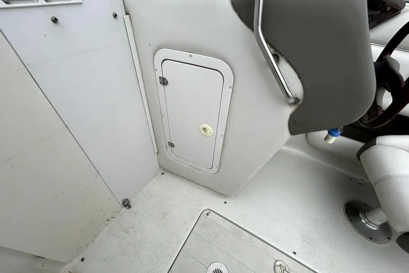 Slide: The Image of 2001 Crownline 239 DB boat interior with storage compartment and seating area. - 23