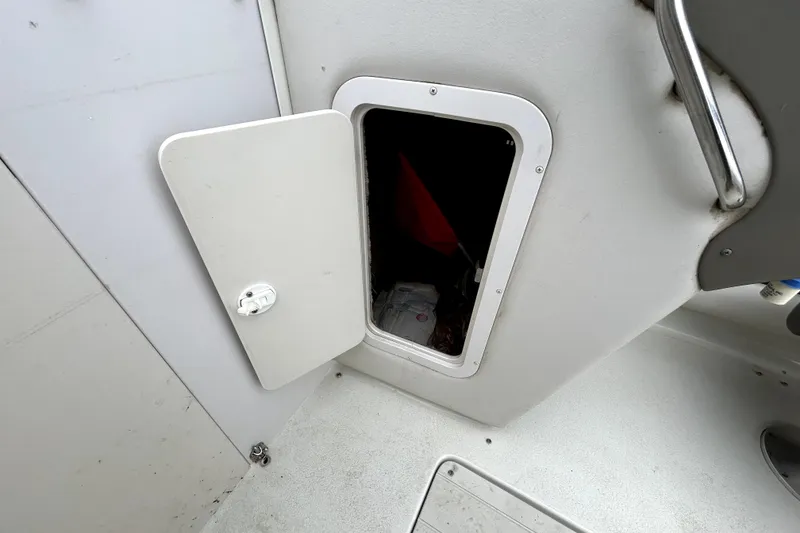 Slide: The Image of Open storage compartment on a 2001 Crownline 239 DB boat interior. - 24