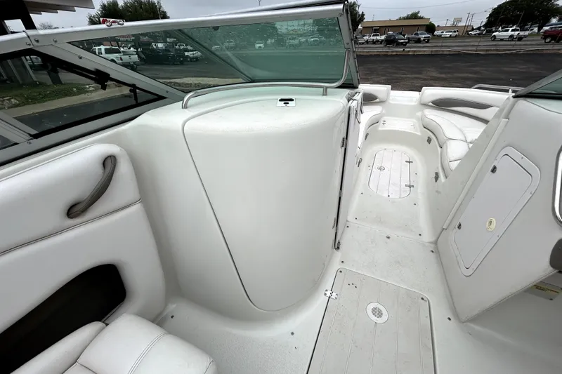 Slide: The Image of 2001 Crownline 239 DB boat interior with white seating and storage compartments. - 25