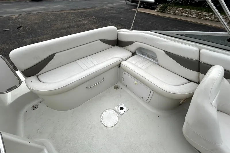 Slide: The Image of 2001 Crownline 239 DB boat interior with white seating and storage compartments. - 27