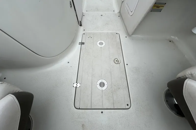 Slide: The Image of 2001 Crownline 239 DB boat interior floor with storage hatch and seating. - 28