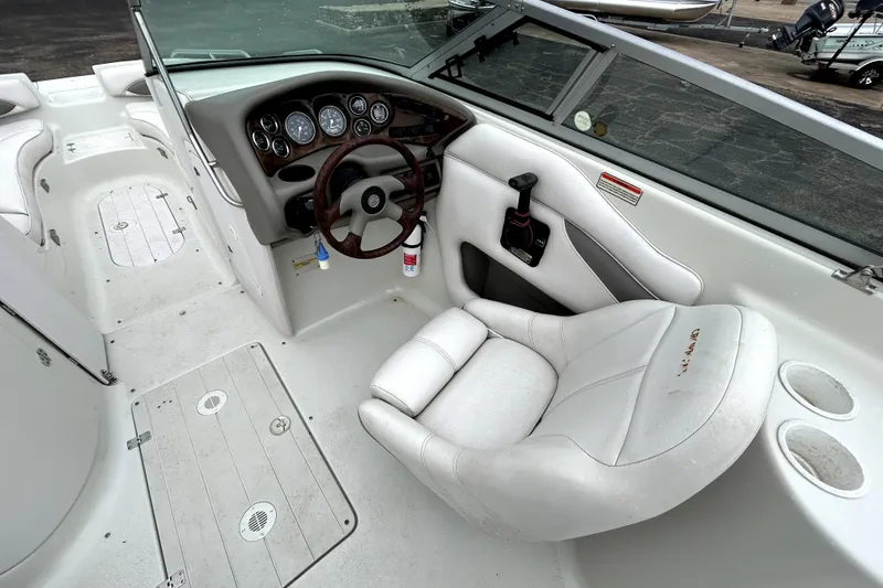 Slide: The Image of 2001 Crownline 239 DB boat interior with steering wheel and white seating. - 31