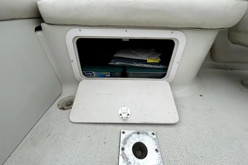 Slide: The Image of Storage compartment on a 2001 Crownline 239 DB boat, open with visible contents. - 35