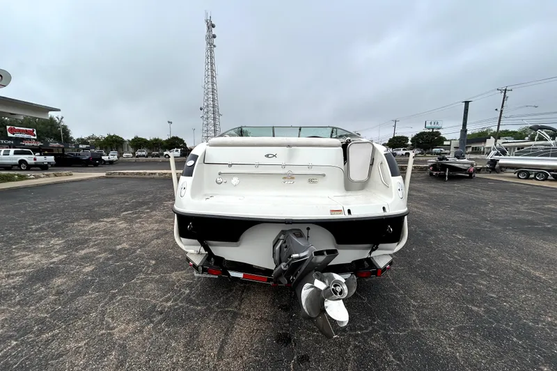 Slide: The Image of Rear view of a 2001 Crownline 239 DB boat in a parking lot. - 6
