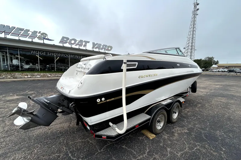 Slide: The Image of 2001 Crownline 239 DB boat on trailer at dealership, rear view. - 7
