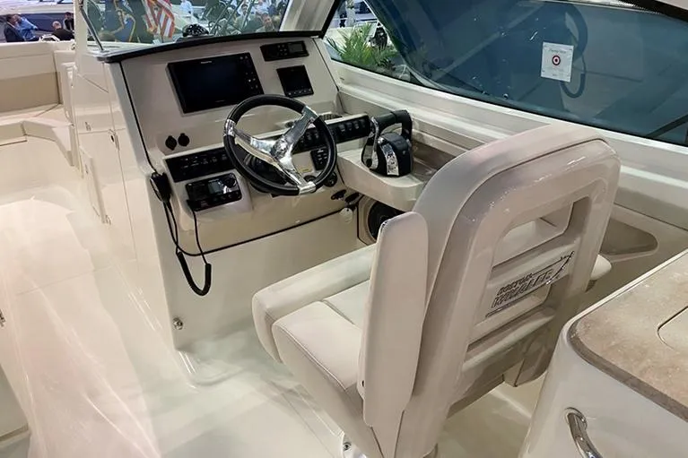 Slide: The Image of Manufacturer Provided Image: 2026 Boston Whaler 280 Vantage boat interior with steering wheel and control panel. - 11