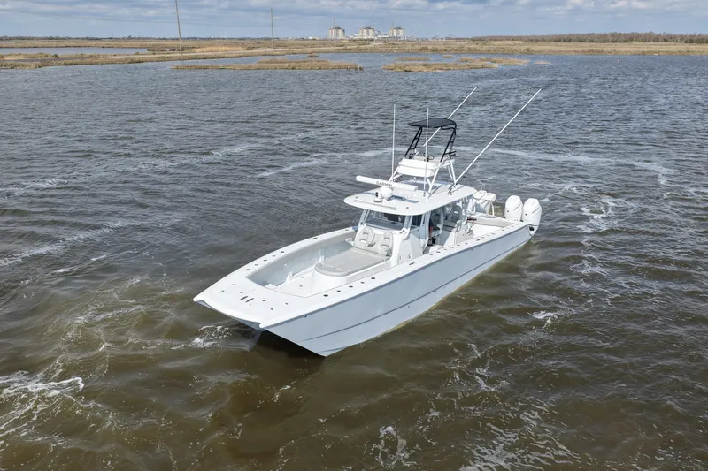 Slide: The Image of 2025 Freeman 42LR boat cruising on open water, showcasing sleek design and powerful engines. - 10