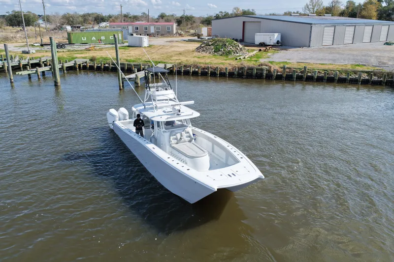Slide: The Image of 2025 Freeman 42LR boat on water near dock, industrial background. - 24