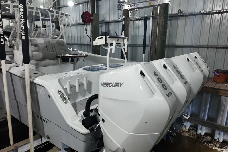 Slide: The Image of Freeman 42LR 2025 boat with four Mercury 400 engines in a docked setting. - 28