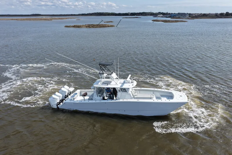 Slide: The Image of 2025 Freeman 42LR boat cruising on open water with scenic background. - 3