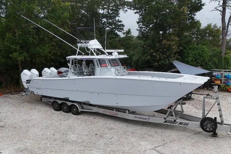 Slide: The Image of 2025 Freeman 42LR boat on trailer, surrounded by trees and gravel. - 30