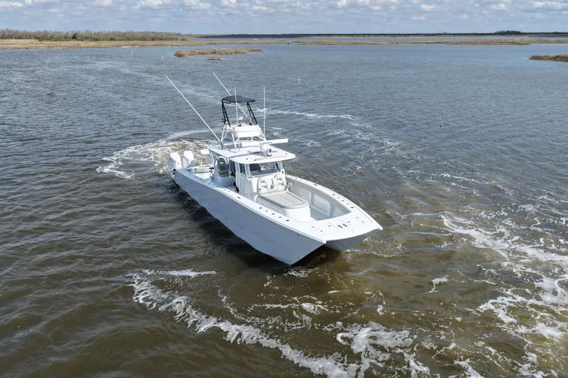 Slide: The Image of Freeman 42LR 2025 boat navigating through calm waters under a cloudy sky. - 5