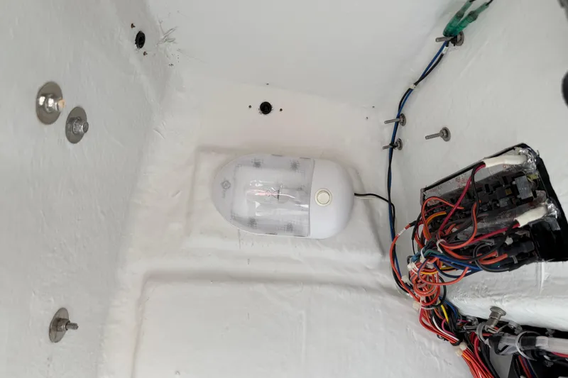 Slide: The Image of Electrical wiring and light fixture inside a 2016 Sportsman Heritage 231 Center Console boat. - 102