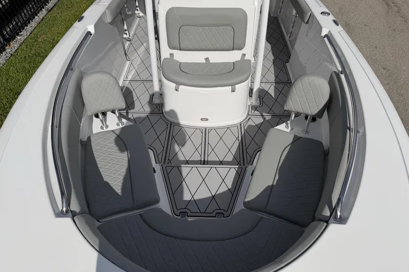 Slide: The Image of 2016 Sportsman Heritage 231 Center Console boat interior with gray seating and diamond-patterned flooring. - 104