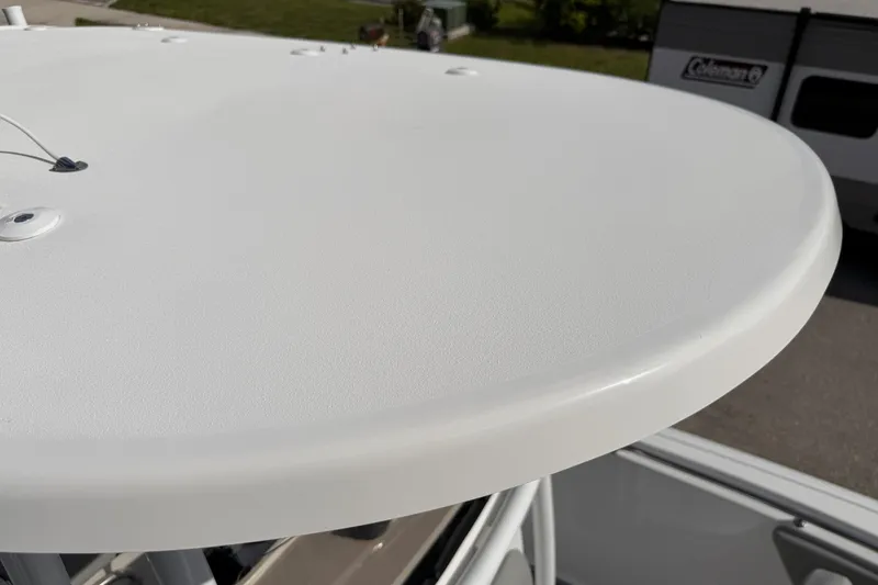 Slide: The Image of 2016 Sportsman Heritage 231 Center Console boat's T-top detail in outdoor setting. - 107