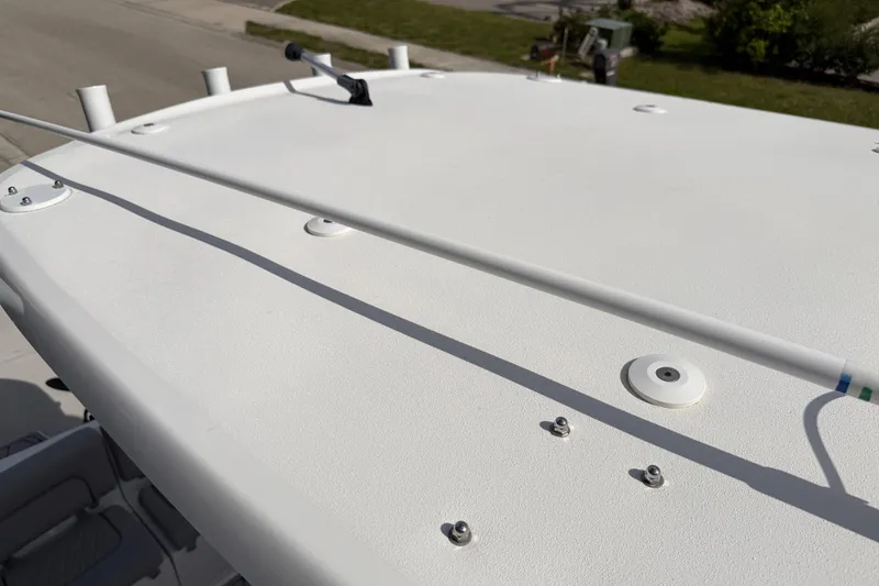 Slide: The Image of 2016 Sportsman Heritage 231 Center Console boat roof with mounted rod holders. - 108