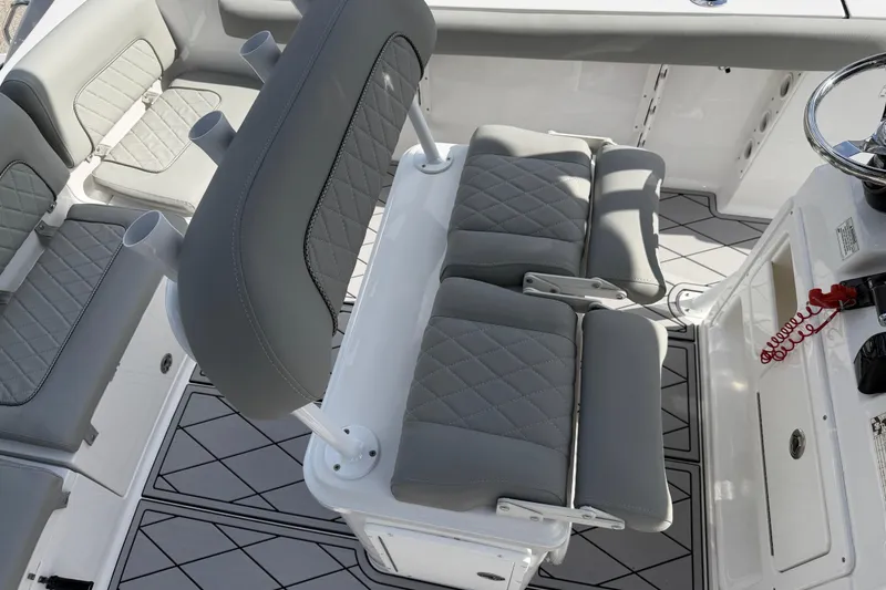 Slide: The Image of 2016 Sportsman Heritage 231 Center Console boat interior with gray cushioned seating. - 110