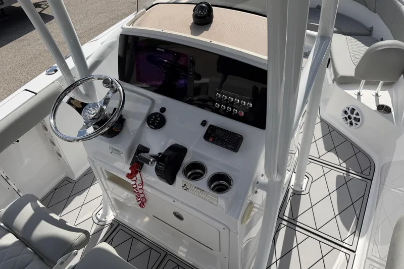 Slide: The Image of 2016 Sportsman Heritage 231 Center Console boat interior with steering wheel and control panel. - 111