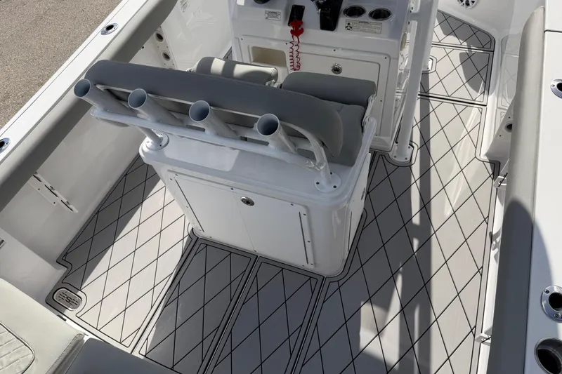 Slide: The Image of 2016 Sportsman Heritage 231 Center Console boat interior with rod holders and cushioned seating. - 113