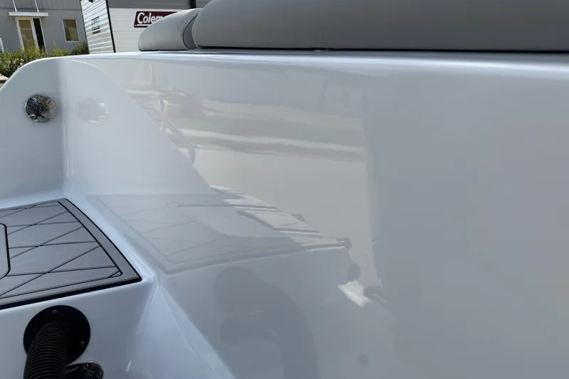 Slide: The Image of 2016 Sportsman Heritage 231 Center Console boat interior, featuring sleek white surfaces and seating. - 118