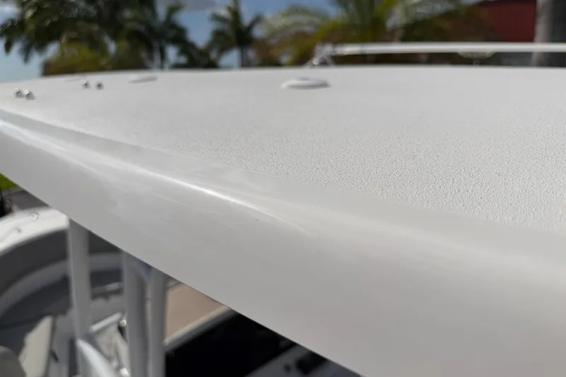 Slide: The Image of Close-up of 2016 Sportsman Heritage 231 Center Console boat's textured surface under sunlight. - 119