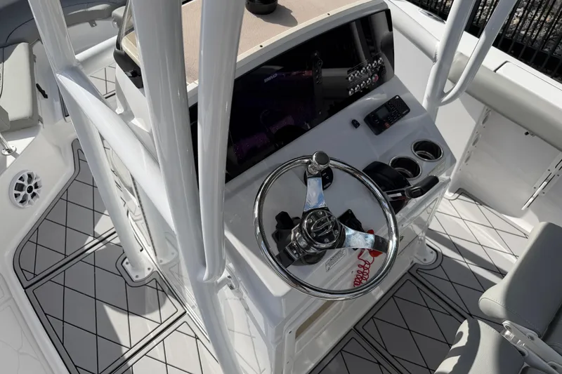 Slide: The Image of 2016 Sportsman Heritage 231 Center Console boat interior with steering wheel and controls. - 122