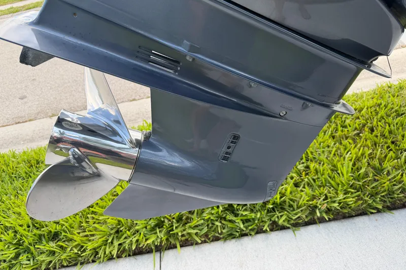 Slide: The Image of Propeller of 2016 Sportsman Heritage 231 Center Console boat on grass. - 15