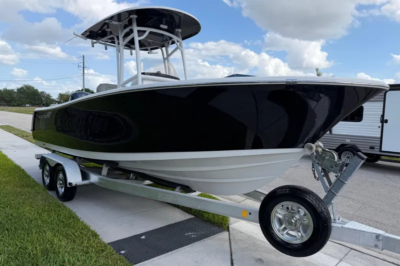 Slide: The Image of 2016 Sportsman Heritage 231 Center Console boat on trailer, parked outdoors. - 19