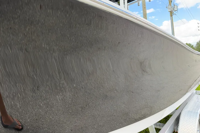 Slide: The Image of 2016 Sportsman Heritage 231 Center Console boat hull on trailer, reflecting surroundings. - 21