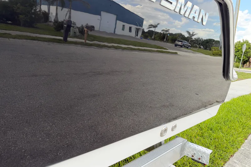 Slide: The Image of 2016 Sportsman Heritage 231 Center Console boat reflecting street and greenery. - 24